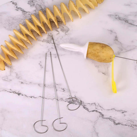 Manual Tornado Potato Spiral Cutter with potato on white plunger; yellow handle and metal skewers on marble surface