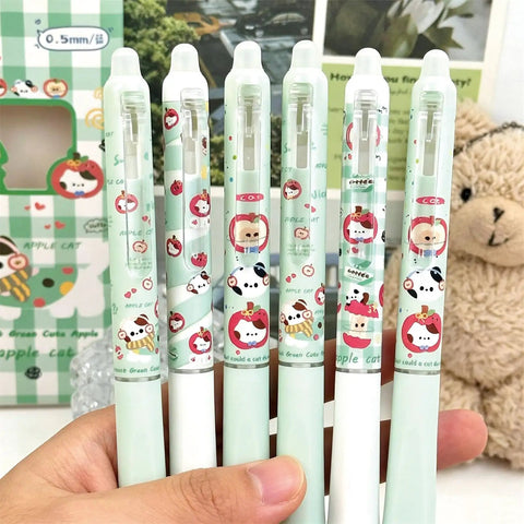 Close-up of six Four Piece Erasable Gel Pens With Retractable Cat Cartoons 0.5mm Black Ink Green Cat Pattern held in hand.