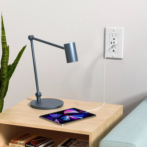 Haul This Smooth Usb Wall Outlet With Two Type C And One Type A Ports For Reliable Six Amp Fast Charging To Keep Every Gadget Pumped Full Of Juice No Fuss Ever Just Install And Go In Classic White, mounted next to a modern desk lamp and tablet.