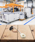 High Precision Dc Voltage And Current Meter With Hall Effect Sensor And Smart Alarm System Dual Digital Display on wooden surface with machinery background.