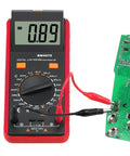 LCR Meter Capacitance Inductance Resistance Tester with LCD overrange display connected to a circuit board