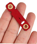 Hand holding a red suede foot ring with holes, part of the Soft Bird Foot Muffs And Leg Bands Set For Parrots, Pigeons, Cockatiels.