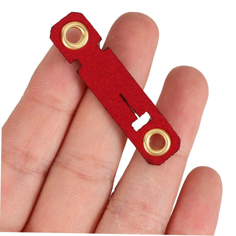 Hand holding a red suede foot ring with holes, part of the Soft Bird Foot Muffs And Leg Bands Set For Parrots, Pigeons, Cockatiels.