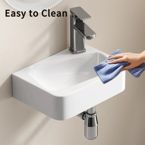 HAOCHRYSYPH Wall-Mounted Bathroom Sink, Ceramic, Milk White, 14x10 in. Being cleaned with a cloth for easy maintenance.