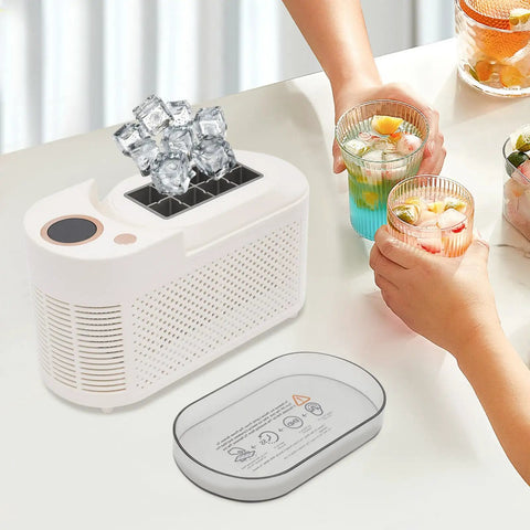 Quick Chill Portable Ice Cube Maker For Home Or Car with ice cubes, compact white design, and two colorful drinks on table.