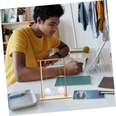 Student using Two Pack Physics Learning Tool For Floating Ball Experiments, wooden kit visible on desk.