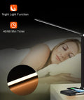 8 In 1 4th Gen Multifunctional LED Desk Lamp With 10W Fast Wireless Charger displayed beside sleeping person at night