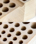 Close-up of beech wood Pro Grade Leatherworking Tool Rack 46 hole organizer showing details of wood grain and tool slots.
