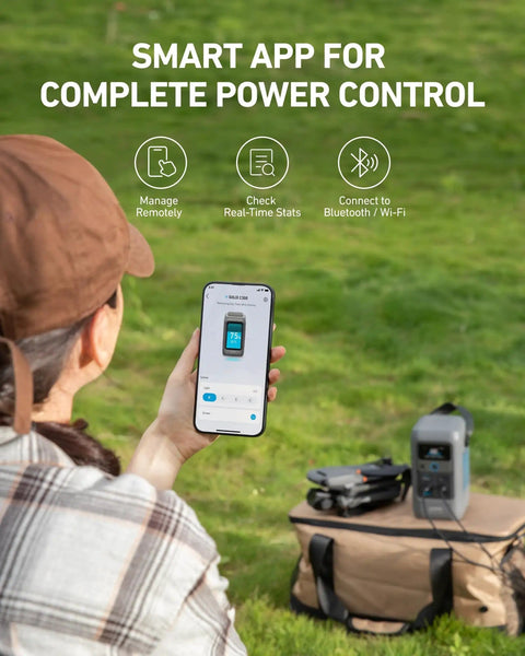 Person controlling 192Wh Portable Power Station With LiFePO4 Battery, 200W Solar Generator using smartphone app outdoors.