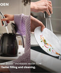 Moen Jaslynn Pulldown Kitchen Faucet, Chrome, 87618 spraying water over a plate in a kitchen setting.