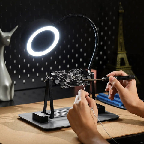 Person using Magnetic Adjustable Circuit Board Holder With 360 Degrees Rotating Clamps for soldering under ring light