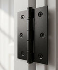 Close-up of a mounted 12 Pack Black 2.5 Inch Door Hinges With Screws For Doors Cabinets Furniture And DIY Projects Mini Metal Butt Hinges