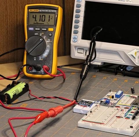 Two Pack Multimeter Test Lead Set With Wire Piercing Probes And Insulated Back Probes For Diagnostic Electrical Testing, shown in use on a circuit board