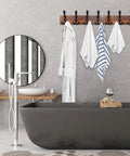 Rustic Wood Wall Mounted Coat Rack With Eight Black Tri Hook Rails, 31 Inch Long Entryway Organizer in bathroom with towels