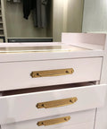 Antique Brass Zinc Alloy Cabinet Handle With Backplate installed on white drawers in a bedroom setting, 5 Inch Center to Center.
