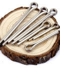 220 Piece Cotter Pin Assortment Kit For Automotive Workshop And Engine Repairs, DIY Friendly And Easy To Use Dowel Hardware Set With Mixed Sizes For Cars, Trucks, And Fast Fixes. Silver steel cotter pins on wood slice, assorted sizes
