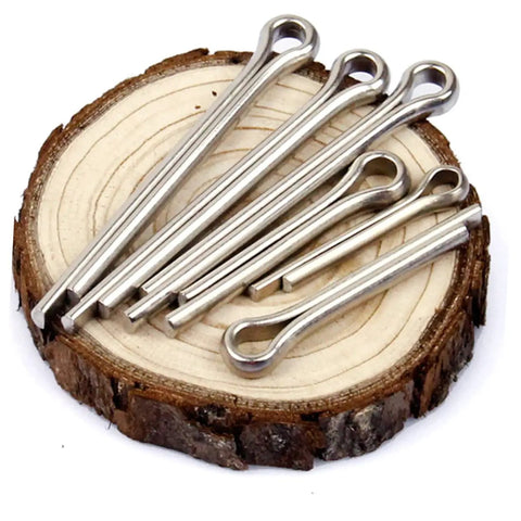 220 Piece Cotter Pin Assortment Kit For Automotive Workshop And Engine Repairs, DIY Friendly And Easy To Use Dowel Hardware Set With Mixed Sizes For Cars, Trucks, And Fast Fixes. Silver steel cotter pins on wood slice, assorted sizes