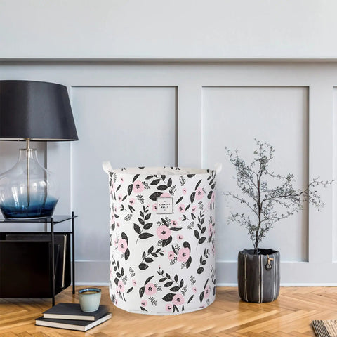 Foldable Laundry Basket Hamper With Handles, Portable Tall Collapsible Canvas Bin With Waterproof Lining, Floral Pink Nursery And Household Storage Organizer For Laundry, Toys And More No Fuss in a room setting.