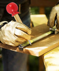 Using No Fuss Boss Level Automatic Center Punch And Emergency Glass Breaker to mark wood with a measuring tool.