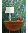 Heavy Duty Tropical Leaf Exotic Textured Vinyl Wallpaper, Slick Leather Finish Wall Covering For Walls, displayed behind a lamp.