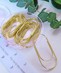 Oversized Gold Paper Clips Set, Big Ol Jumbo 2 Inch 50mm Clips, 20 Pack displayed in round container on white surface