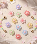 Pastel Jelly Daisy Flower Shoe Charms Set With Glossy Bling Floral Buckles, assorted colors on fabric background.