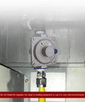 Installed natural gas pressure regulator; 1 in inlet/outlet, 3/4 in FPT threads; gray metal body with blue adjustment knob.