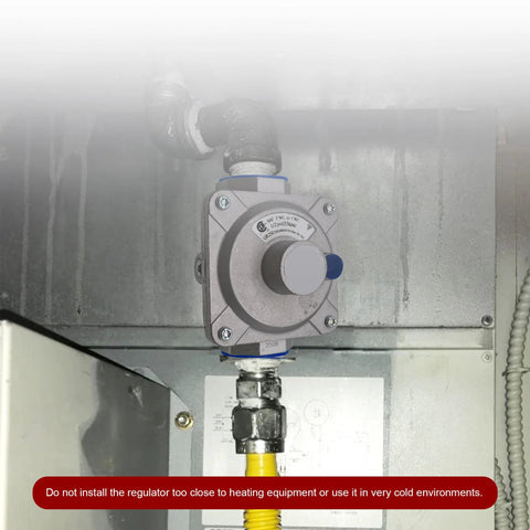 Installed natural gas pressure regulator; 1 in inlet/outlet, 3/4 in FPT threads; gray metal body with blue adjustment knob.