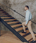 Matte Black Industrial Pipe Handrail Non Slip Wall Mounted Stair Banister No Fuss Setup Solid Grip For Indoor Outdoor Use shown in use on stairs.