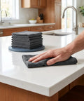 Person using Must-Have Thick Reusable Microfiber Cloths For Kitchen And Car, Lint Free And Streak Free, 16 By 12 Inch, 5 Pack on countertop