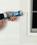 Person applying Dynaflex 230 Pro Elastomeric Sealant White 10.1 Oz to window frame using 4 inch nozzle