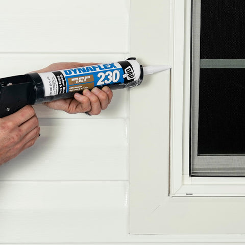 Person applying Dynaflex 230 Pro Elastomeric Sealant White 10.1 Oz to window frame using 4 inch nozzle