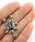 Hand holding 100 Pcs 6 mm Antique Silver Flying Saucer Spacer Beads European Style Metal Beads For Jewelry Making, Bracelets And Necklaces, Dope For Pandora DIY Projects