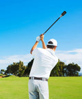 Golfer using Stainless Steel Golf Swing Trainer For Power And Flexibility Training on a course, showing swing motion and posture.