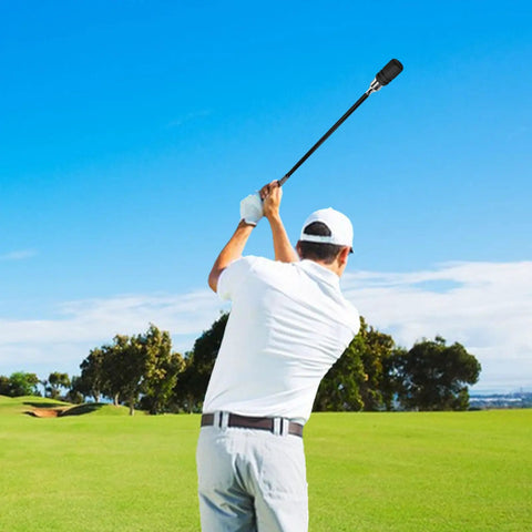 Golfer using Stainless Steel Golf Swing Trainer For Power And Flexibility Training on a course, showing swing motion and posture.