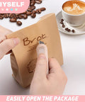 Using 8 Pack Mini Box Cutters for Packages and Projects to open a paper bag near coffee beans and a cup of latte.