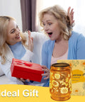 Two women exchanging gift with Solar Lanterns Outdoor Hanging Lights Waterproof For Yard Patio Porch Garden LED Decoration With Shepherd Hook Sunflower Pattern Cozy Warm Glow For Nighttime Ambiance Perfect Gift For Women Mom Grandma.
