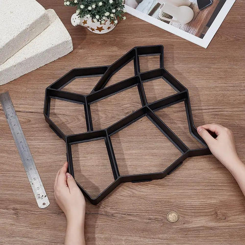 Hands holding 2 Pack Concrete Path Molds For Walkways And Patios 14.17x14.17x1.38 Inch Square Stone Pattern Reusable Forms