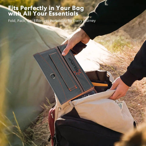 Person packing Go-To 10000mAh Solar Charger with 30W Foldable Panels into a backpack for outdoor use.