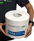 Heavy Duty Industrial Cleanroom Wipes, Lint Free Cellulose Polyester Blend Shop Rags For Nitty Gritty Grease And Oil Cleanup, 8X12 Inch Rolls Of 500 Pro Grade Workhorse Sheets held by a person.