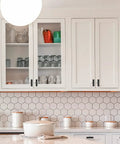 White kitchen cabinets with Matte Black 2 Inch Square Cabinet Knobs And Pulls, 15 Pack, Stainless Steel Bar Style Handles visible