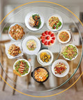 Large 36 Inch Tempered Glass Lazy Susan Turntable With Silent Smooth 360 Rotation Heat Resistant Serving Tray with various dishes.