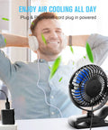 Person relaxing with USB Clip On Desk Fan With Sturdy Clamp Tiny But Mighty Portable Personal Fan on desk, corded power visible