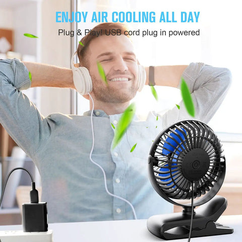 Person relaxing with USB Clip On Desk Fan With Sturdy Clamp Tiny But Mighty Portable Personal Fan on desk, corded power visible