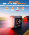 All In One Car Jump Starter With Air Compressor And Tire Inflator with 800 lumens light and SOS strobe on roadside at twilight