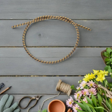 Replacement Control Cable For Riding Lawn Mowers And Tractors 100cm Iron Shaft Core on wooden background with garden tools