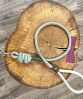 Braided Cotton Rope Half Inch Natural Beige Soft Utility Cord Fifty Feet For DIY Projects Home And Garden All Purpose Heavy Duty Craft Rope For Camping And Outdoor Use coiled on wooden surface.