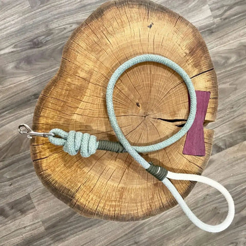 Braided Cotton Rope Half Inch Natural Beige Soft Utility Cord Fifty Feet For DIY Projects Home And Garden All Purpose Heavy Duty Craft Rope For Camping And Outdoor Use coiled on wooden surface.