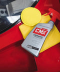 CMX Ceramic Spray Coating For Cars 24 Oz Easy To Apply Pro Grade Long Lasting Protection With SiO2 TiO2 next to red car