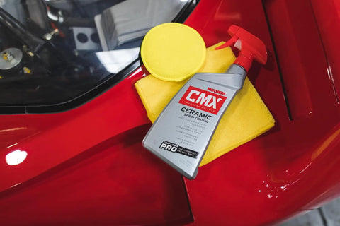 CMX Ceramic Spray Coating For Cars 24 Oz Easy To Apply Pro Grade Long Lasting Protection With SiO2 TiO2 next to red car